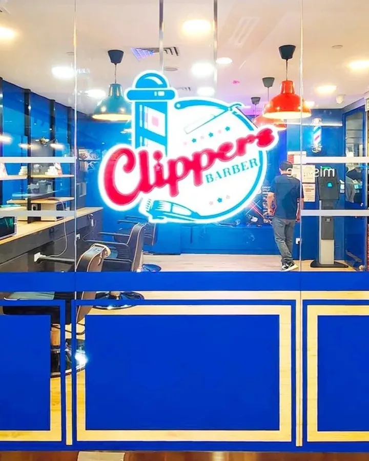 A Clippers Barber barber giving a modern men’s haircut